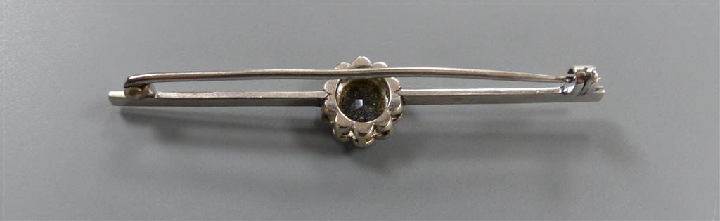 An early 20th century white metal , sapphire and diamond cluster set bar brooch, 58mm, gross 3.3 grams.